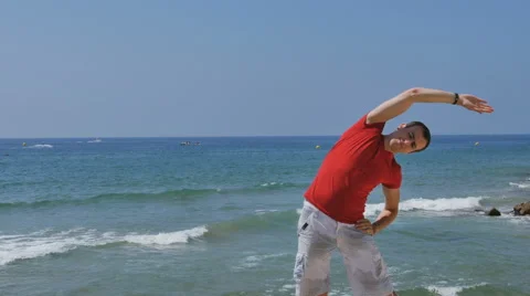 Athletic, young, healthy, handsome, white man warming up his body before the Stock Footage 64891907