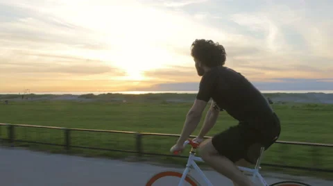 Athletic young man biking in the sunset Stock Footage 51466005