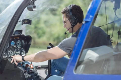 Athletic young man checking parameters of helicopter Stock Photos