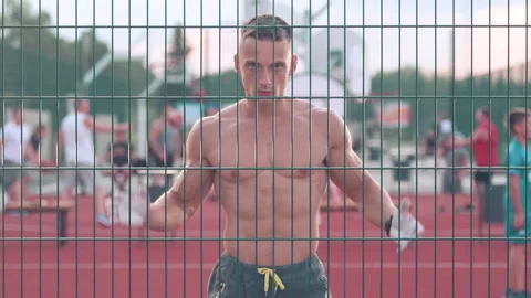 Athletic young man claps hands walking around basketball court looking straig Stock-Footage 159478003