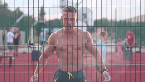 Athletic young man claps hands walking around basketball court looking straig Stock-Footage 159478255