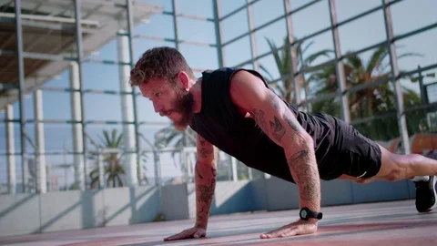 Athletic young man concentrated doing push ups workout outdoor at early sunny Stock-Footage 117130151