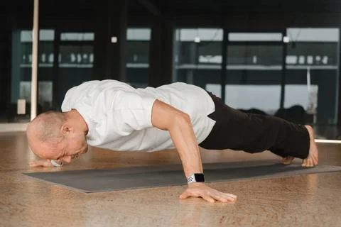 An athletic young man does exercises in the fitness room. A professional guy  Foto stock
