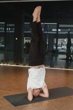 An athletic young man does exercises in the fitness room. A professional guy  Stock Photos