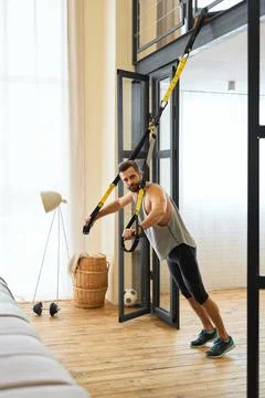Athletic young man doing exercise with resistance band Stock Photos