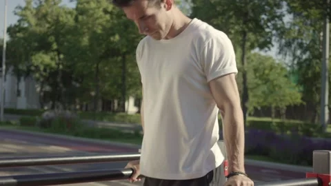 Athletic young man doing parallel bar dips on urban sports ground Stock Footage 146307497