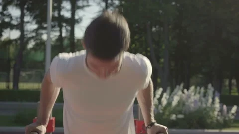 Athletic young man doing parallel bar dips on urban sports ground Video stock 146307824