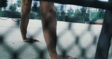 Athletic young man doing push ups while listening to music Stock Footage 85489188