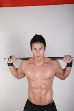 Athletic young man doing workout with weights Stock Photos