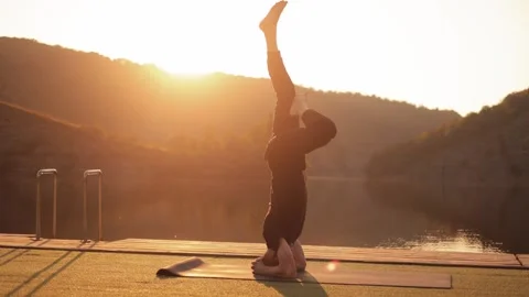 Athletic young man doing yoga outdoors in the morning. Concept of freedom,  yoga Stock Footage 246559163