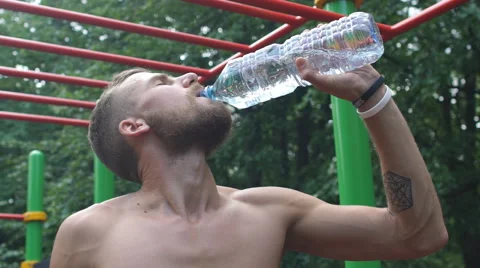Athletic young man drinking water from a bottle Stock Footage 68023329