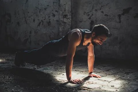 Athletic Young Man Exercise In Old Factory Building Foto stock