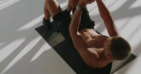 Athletic Young Man Exercises in Studio with Intensity and Focus Stock Footage 344278109