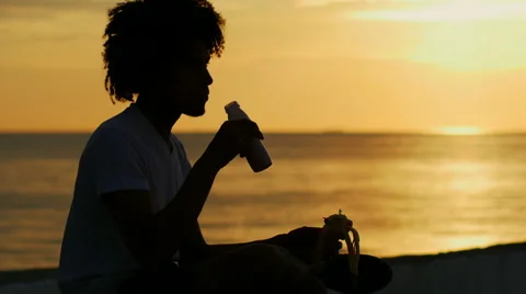 Athletic young man having breakfast at the seaside Stock Footage 50209882