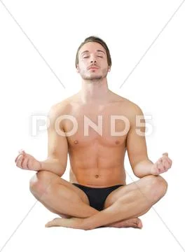 Athletic young man meditating in lotus position on white Stock Photos
