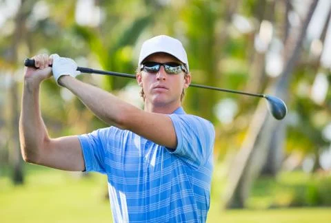Athletic young man playing golf 写真素材