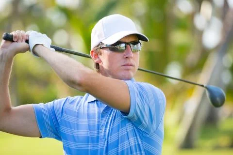 Athletic young man playing golf Stock Photos