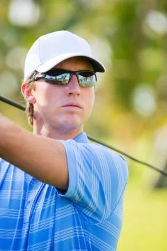 Athletic young man playing golf 写真素材