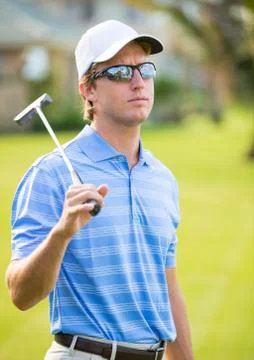 Athletic young man playing golf Stock Photos