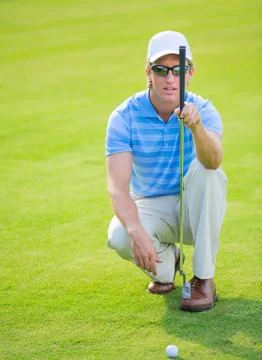 Athletic young man playing golf Stock Photos