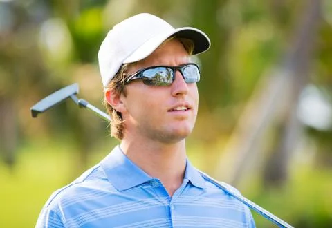 Athletic young man playing golf Stock Photos