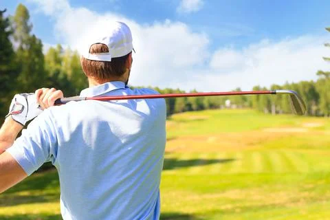 Athletic young man playing golf in golfclub. 스톡 사진