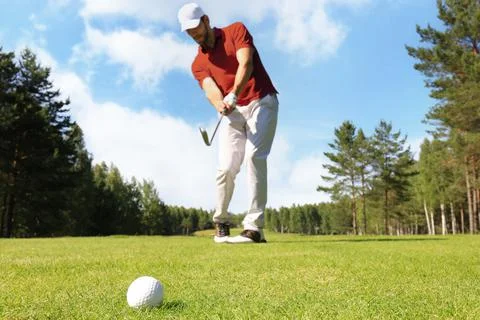 Athletic young man playing golf in golfclub. 스톡 사진
