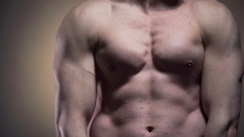 Athletic young man is posing and flexing his muscles in 4k Stock Footage 109533533