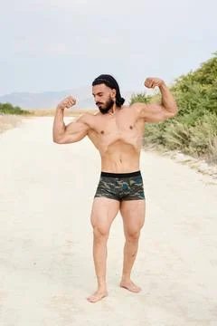 Athletic young man posing on the beach Foto stock