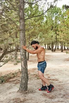Athletic young man posing on the beach Foto stock