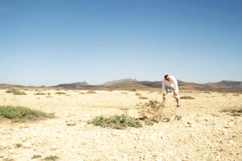 Athletic young man running at the desert, slow motion Stock Footage 1089346
