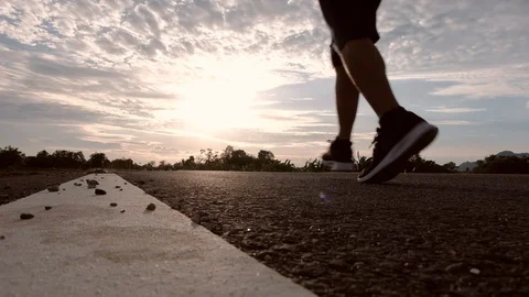 Athletic young man running on the road at sunset. Elderly men running for health Stock Footage 113398183