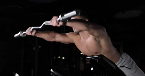 Athletic young man training in the gym with a bodybar, lying down doing Stock Footage 160208371