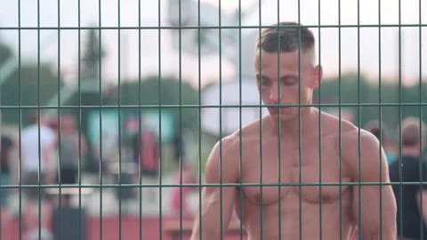 Athletic young man walking around basketball court with a ball and looking st Stock Footage 159477907