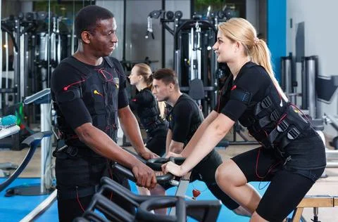 Athletic young people during functional workout with electric muscle stimulation Stock Photos