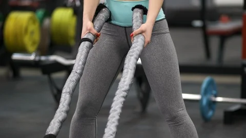Athletic young woman doing crossfit exercises with a rope. close up 스톡 동영상 125059853