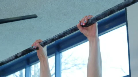Athletic young woman doing pull-ups on a horizontal bar at fitness gym Stock-Footage 106197326