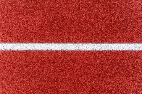 Athletics running rubber  track texture with white line on stadium. Background. Stock Photos
