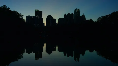 Atlanta Skyline Night Sunset Silhouette Pan Lake Reflection at Piedmont Park Stock Footage