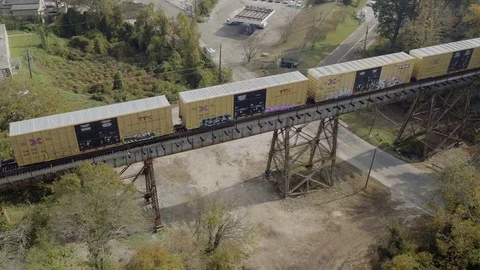 Atlanta Skyline to Tilt down of  Train on Railroad bridge tracks. Stock Footage 82448274