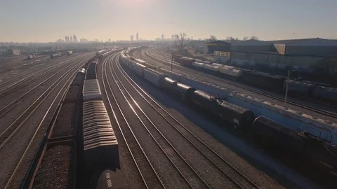 Atlanta train yard drone pulls back skyline in bkg Stock Footage 85365721