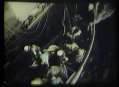 ATLANTIC - 1944: Boat handling - Men work a rope ladder above the water Vidéo 343931996