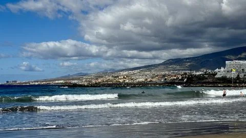 Atlantic coastline with rolling waves, volcanic shore and mountain backdrop o Stock-Fotos