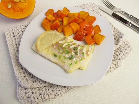 Atlantic cod fillet and red kuri squash Foto stock