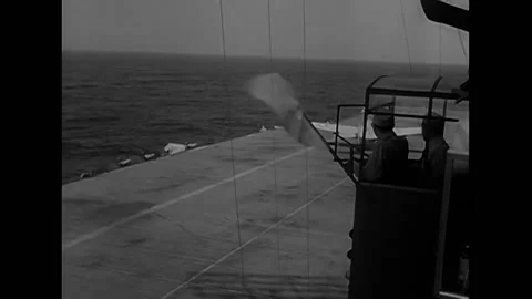 ATLANTIC OCEAN - 1942 - Crewmen on the USS Ranger go up an elevator to the Stock Footage 325202956