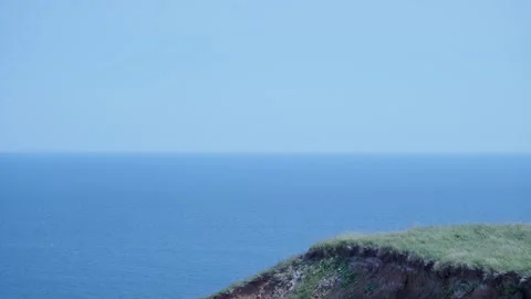 Atlantic ocean with hills in the foreground Stockbeeldmateriaal 317125029