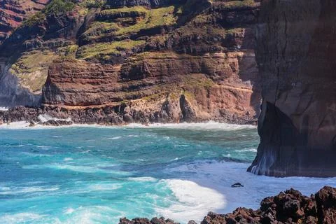 Atlantic ocean wave breaks on the big rocky stone on the beautiful beach of.. Stock Photos
