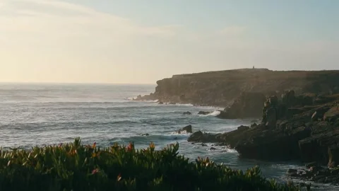 Atlantic Ocean Waves Breaking Against Rocky Cliffs at Sunset. Stock Footage 327039414