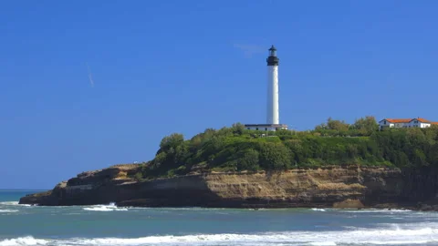 Atlantic Ocean waves breaking along the coastline and lighthouse of Biarritz Vídeo Stock 340209342