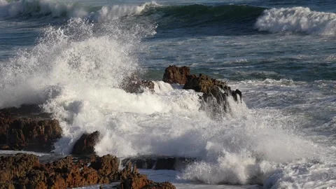 Atlantic Ocean waves breaking onto the rugged, rocky coastline at Hermanus Stock Footage 306828222